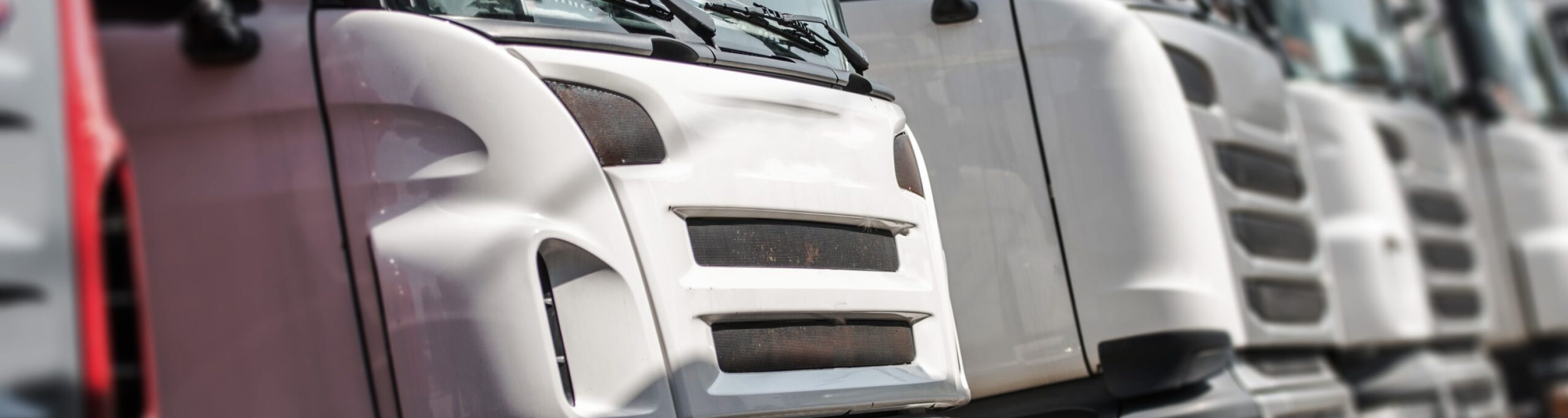 Pre Owned Euro Trucks For Sale. Row of Trucks with Shallow Depth of Field.